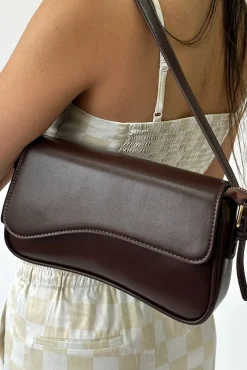 Curved Baguette Bag In Dark Brown by SVNX