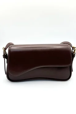 Curved Baguette Bag In Dark Brown by SVNX