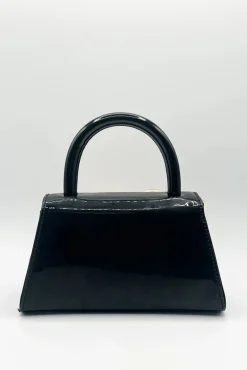 Metallic Bow Top Handle Bag In Black by SVNX