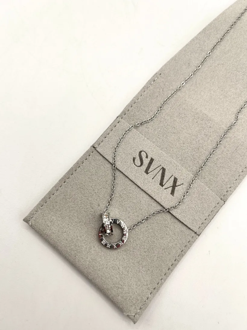 Roman Numeral Necklace In Silver by SVNX