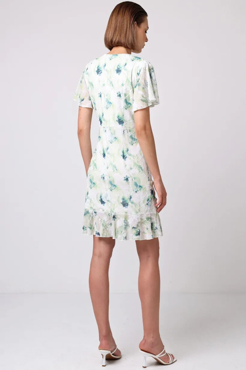 Wrap Ruched Mini Dress With Ruffle Hem In Green Floral Burnout Print by Angeleye