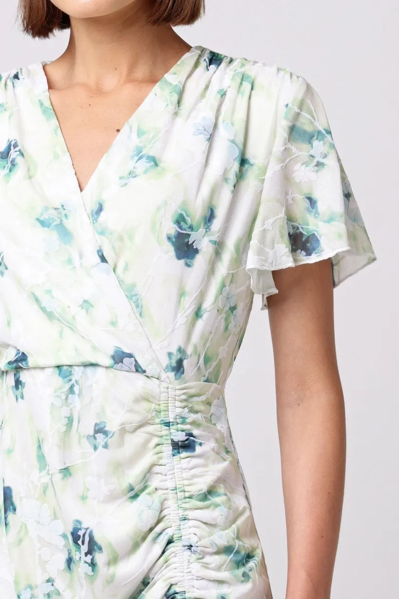 Wrap Ruched Mini Dress With Ruffle Hem In Green Floral Burnout Print by Angeleye